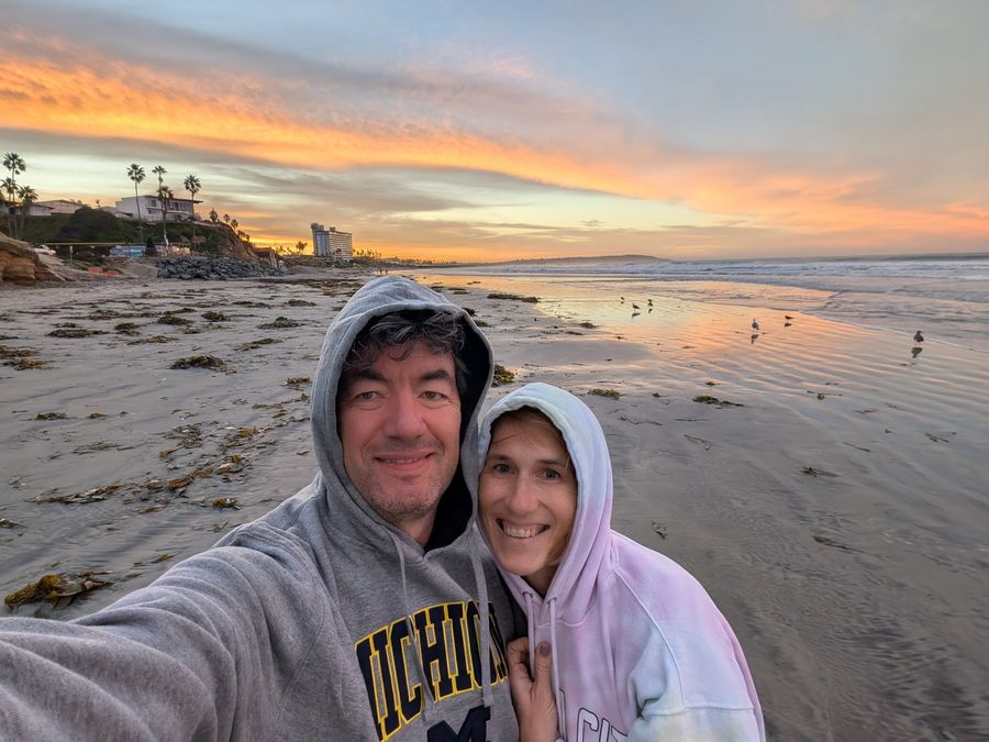 Ken and Lisa in hoodies at Shell Beach in La Jolla, California, low tide and seabirds at sunset